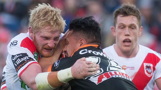 At his own risk ... James Graham of the Dragons tackles Sauaso Sue of the Tigers.