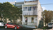 Despite its crumbling condition, the home sold for $355,000 more than its reserve.