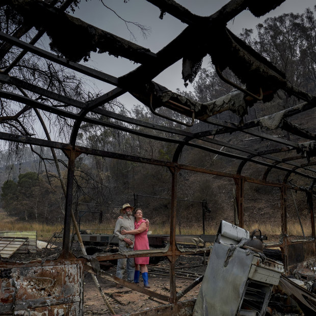 Mark Brooks with his daughter Kylee at his home, which was destroyed by bushfires. 