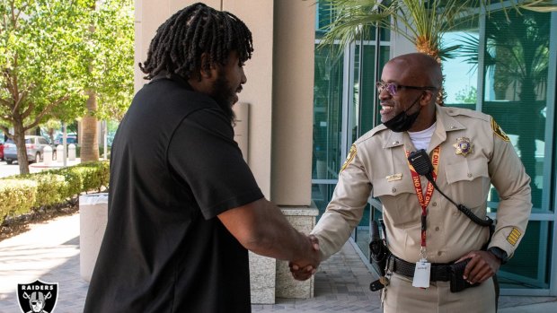 Lieutenant Kendall Bell with Las Vegas Raiders guard Dylan Parham.