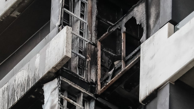 Firefighters inspect the damage at the Neo200 tower.