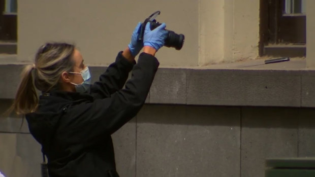 Police photograph a knife at the scene of the CBD incident.