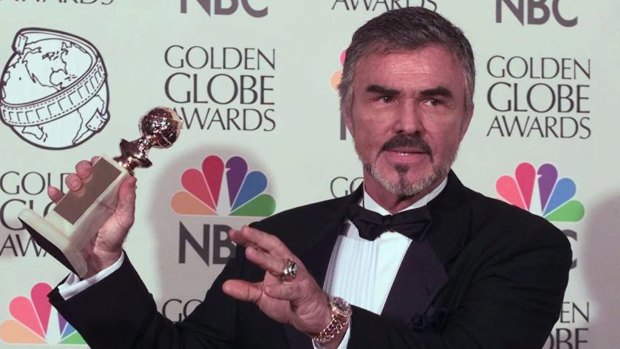 Burt Reynolds holds his award for Best Supporting Actor at the 55th Annual Golden Globe Awards for his role in Boogie Nights. 