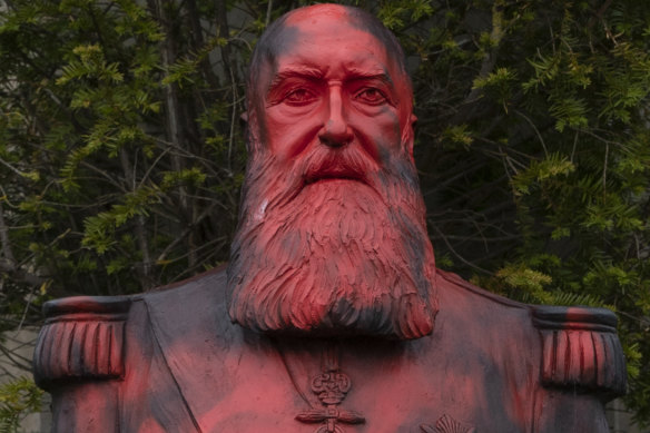 A bust of King Leopold II is smeared with red paint and graffiti in Tervuren, Belgium, last month.