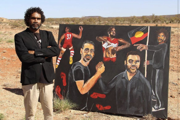 Artist Vincent Namatjira with his Archibald Prize-winning portrait of himself and Adam Goodes.