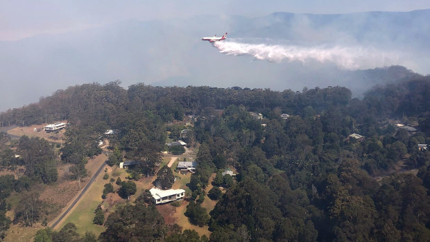 Queensland Fire and Emergency Services' Large Air Tanker drops 15,000L of water over bushfires in Binna Burra.