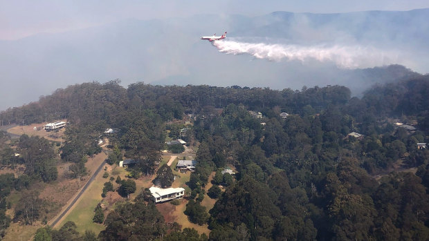 Queensland Fire and Emergency Services' Large Air Tanker drops 15,000L of water over bushfires in Binna Burra.
