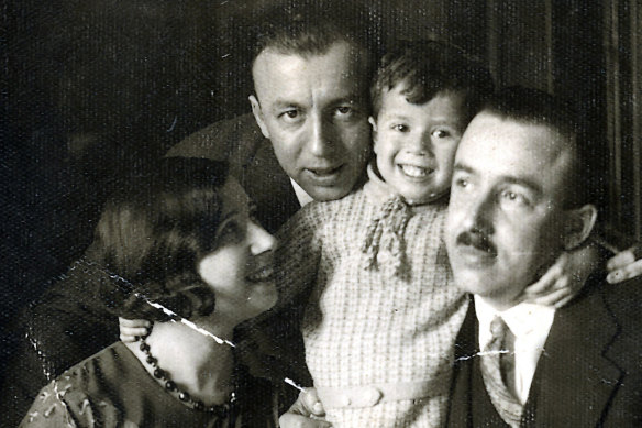 George Szego (centre) with his parents and uncle Max in their loungeroom in Mezobereny.