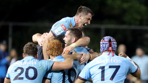 Waratahs players celebrating after beating the Crusaders.