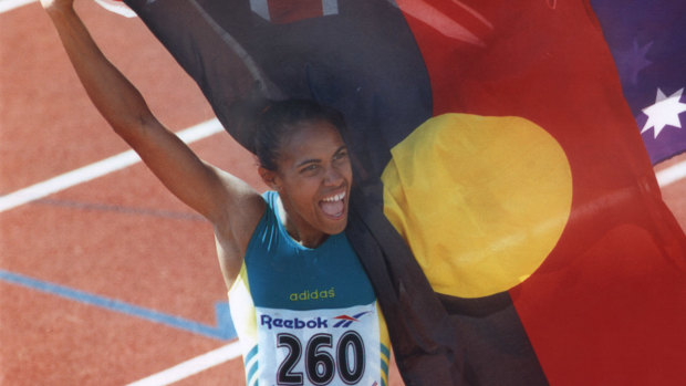 Cathy Freeman with Indigenous flag in Victoria.