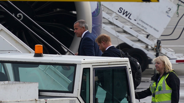 Prince Harry boards a flight at Aberdeen Airport.