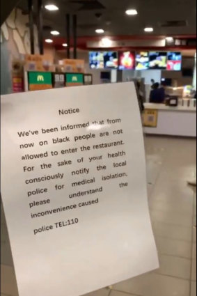 A screengrab from video posted on Twitter showing a sign held by an employee at a McDonald's in Guangzhou, China. The company has since apologised and closed the store for a training session.