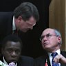 Lynton Crosby speaks with John Howard at a luncheon in Washington in 2002.