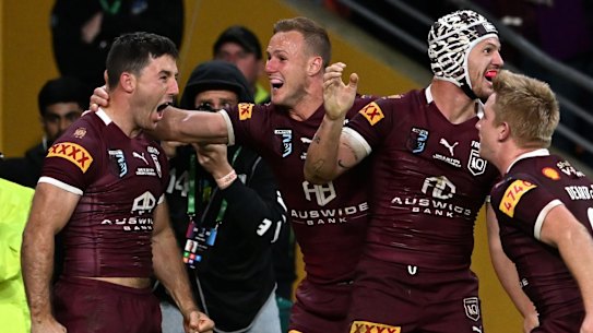 BRISBANE, AUSTRALIA - JULY 13: Ben Hunt of the Maroons  celebrates with teammates after scoring the match winning try during game three of the State of Origin Series between the Queensland Maroons and the New South Wales Blues at Suncorp Stadium on July 13, 2022 in Brisbane, Australia. (Photo by Bradley Kanaris/Getty Images)