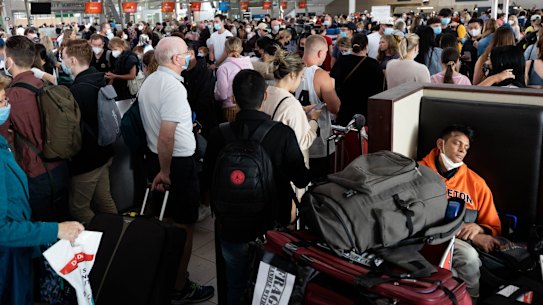 (0400384143) Apprameya Narayana Ilapille sleeps amidst the crowds at Sydney Airport after his 9am Jetstar flight to Brisbane was cancelled and he has to wait for a 4pm Qantas flight instead. 8th April 2022 Photo: Janie Barrett