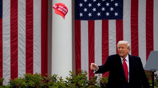 US President Donald Trump tosses a “Make America Great Again” hat during his tariff announcement in the Rose Garden of the White House on Wednesday.
