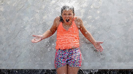 A child reacts to water pouring over her as she stands in the International Fountain at the Seattle Center during a heat wave Wednesday, Aug. 2, 2017, in Seattle. An excessive heat warning for the area continues through Friday evening, as unusually hot weather will bring temperatures nearing a peak of 100 degrees on Thursday. (AP Photo/Elaine Thompson)
