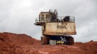Workers sit near a Liebherr excavator in the quarry at the Paragominas bauxite mine, co-owned by Norsk Hydro and Vale SA, in Paragominas, Brazil, on Wednesday, April 13, 2016. Bauxite is extracted from the clay soil, crushed and transported via pipeline to Barcarena for refining and shipment to aluminium producers in Brazil and internationally. Photographer: Paulo Fridman/Bloomberg