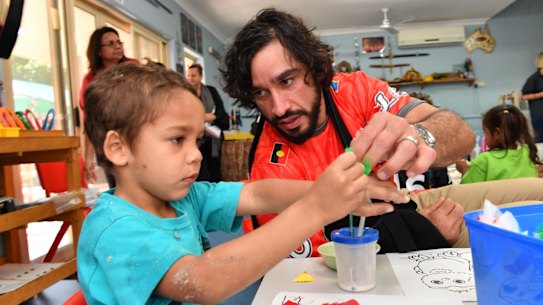 'That’s the one thing that I regretted; that I didn’t apply myself (at school) to have something to fall back on.' Johnathan Thurston with children from the Camp Koobara Aboriginal and Torres Strait Islander Kindergarten in Brisbane. 
