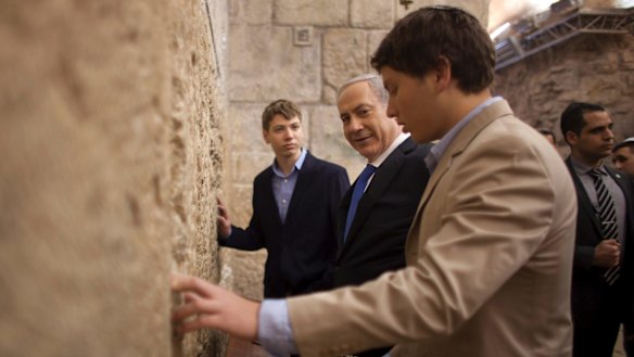  Israeli Prime Minister Benjamin Netanyahu, centre, prays with his sons Yair, background, and Avner, right, at the Western Wall in Jerusalem's Old City in 2013.