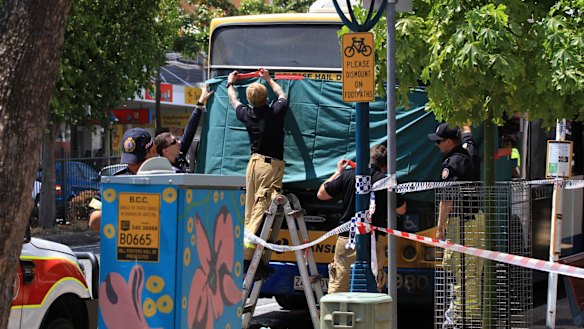 Emergency services cover the bus in which Manmeet Sharma was killed.