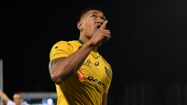 Controversy: Israel Folau celebrates scoring a try for Australia. 