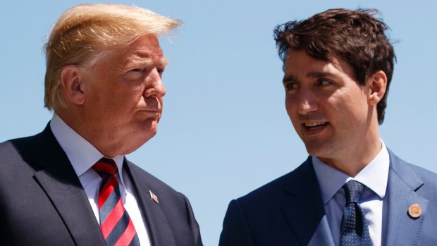 US President Donald Trump talks with Canadian Prime Minister Justin Trudeau during a G-7 Summit welcome ceremony in Charlevoix, Canada, in June.