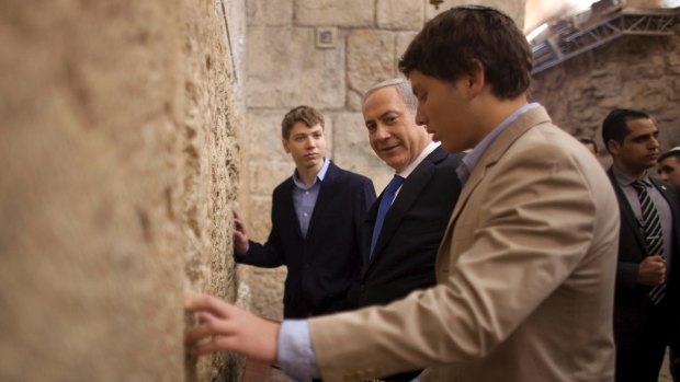  Israeli Prime Minister Benjamin Netanyahu, centre, prays with his sons Yair, background, and Avner, right, at the Western Wall in Jerusalem's Old City in 2013.