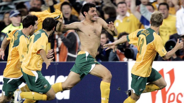 Australian players, from left, Tony Vidmar, Scott Chipperfield, John Aloisi and Vincent Grella celebrate after defeating Uruguay to make the 2006 FIFA World Cup.