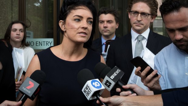 Emma Husar talks to the media outside court after her defamation case against Buzzfeed in Sydney in December.