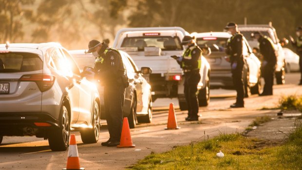 Police enforce the hard border around Melbourne at a roadblock on the Hume Highway in Kalkallo.