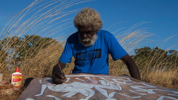 John Mawurndjul, Australian contemporary Indigenous artist working on a bark painting, 