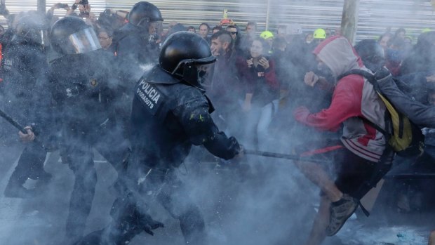 Police charge against protesters during a demonstration by  the Committees for the pro-independence Defence of the Republic in Barcelona, Spain in November. 