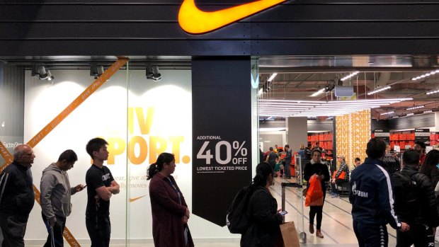 Shoppers queue outside a Nike store in Melbourne for the Black Friday sales. The sales help lift retail sales in November but doubts remain about whether this will be carried through to December results.