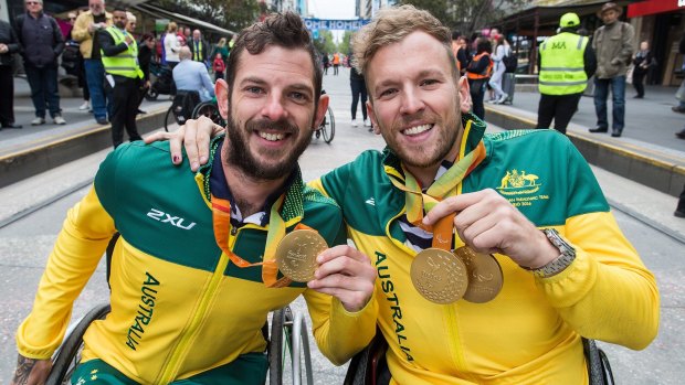 Heath Davidson and Dylan Alcott during a city parade after the 2016 Paralympics.