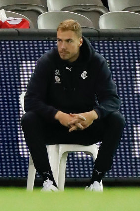 Harry McKay looks on from the bench after leaving the field.