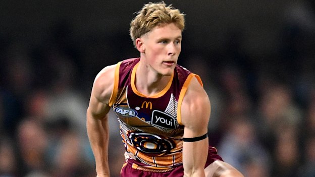 Jaspa Fletcher of the Lions handballs earlier this season.