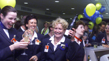 
Ansett staff celebrate at Tullamarine after the arrival of one of the final flights from Brisbane