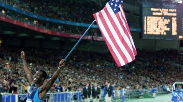 American great Michael Johnson with his nation's flag after 400m gold.