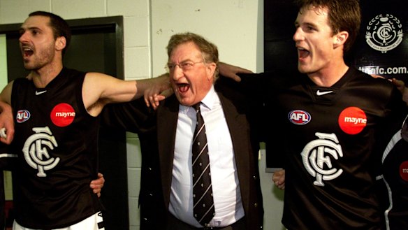 Carlton president John Elliott enjoys a win with players in 2002.