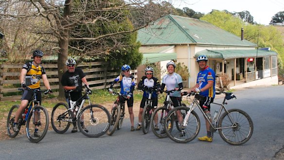 Michael Milton, right, takes a break in Majors Creek during a recent cycle to the coast.