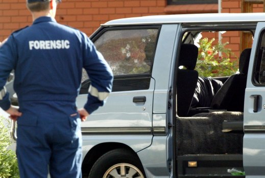 Police examine the van in which Jason Moran and Pasquale Barbaro were murdered.