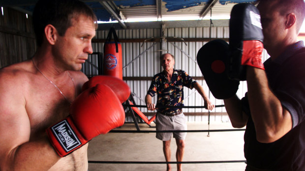 Fighting family: Ricky Thornberry (left) trains with his brother Noel as Trevor watches on in Gatton in 2002.