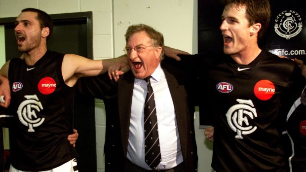 Carlton president John Elliott enjoys a win with players in 2002.