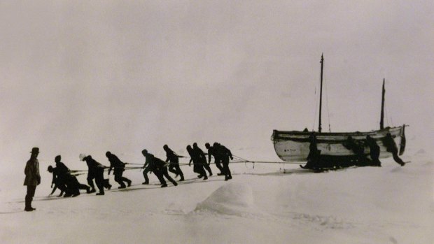 Copy  of a photo taken by Frank Hurley in 1914-15 of the James Caird being towed across ice in Antarctica by Ernest Shackleton and the crew of the Endurance.