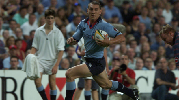 Mat Rogers scores for the Waratahs in the side's 44-21 win over the Golden Cats in 2002. NSW won eight of their 11 games that season before losing by a record margin (96-19) to eventual champions the Crusaders in the final round. 
