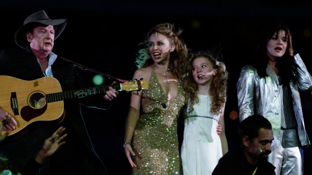 Vanessa Amorosi (right) on stage at the Sydney Olympics alongside Slim Dusty, Kylie Minogue and Nikki Webster