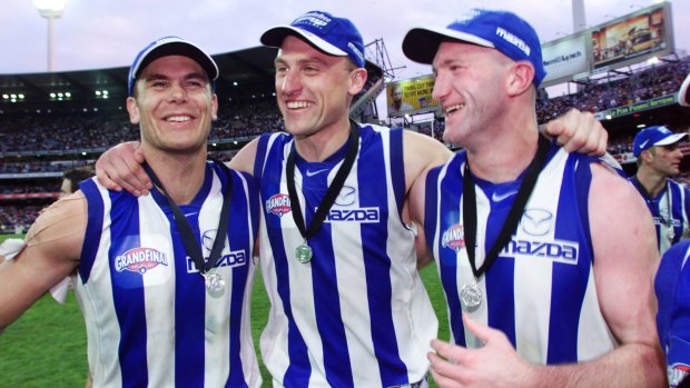 Band's back together: former Kangaroos teammates Wayne Carey (left) and John Longmire (centre) have both been named in the NSW AFL team of the century.