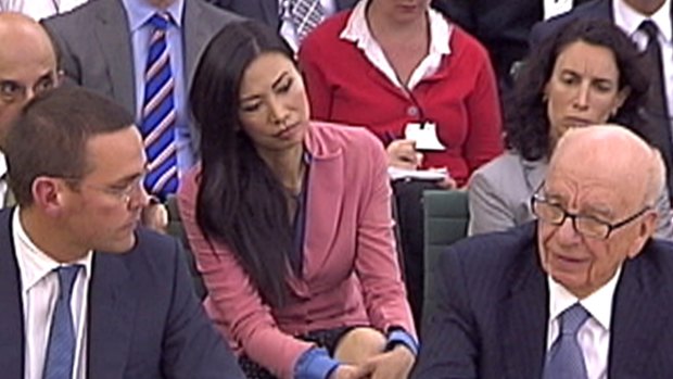 Rupert Murdoch's wife Wendi Deng (C) looks on as BSkyB Chairman James Murdoch and News Corp Chief Executive and Chairman Rupert Murdoch (R) appear before a parliamentary committee on the phone hacking scandal. 