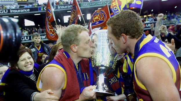 Michael Voss and Justin Leppitsch celebrate winning the 2002 AFL premiership.